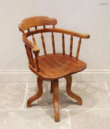 An early 20th century stained beech wood revolving desk chai...