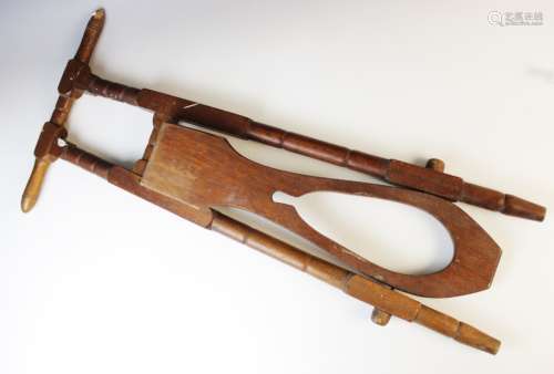 A Victorian turned oak boot jack, 19th century, of typical f...