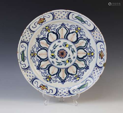 A Delft ware charger, 18th century, the polychrome tin glaze...