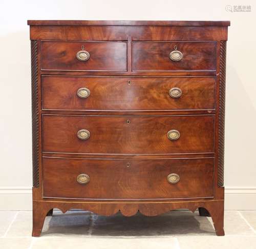 A mid 19th century mahogany bow front chest of drawers, with...