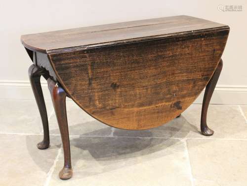 A mid 18th century oval oak drop leaf dining table, raised u...