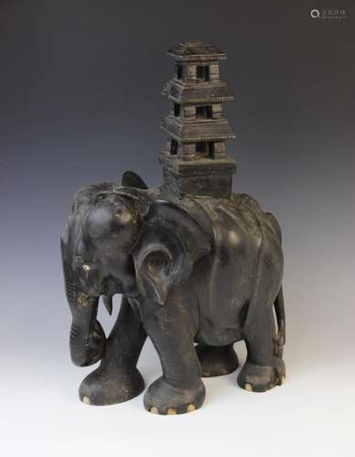 An early 20th century ebony carving of an elephant, modelled...