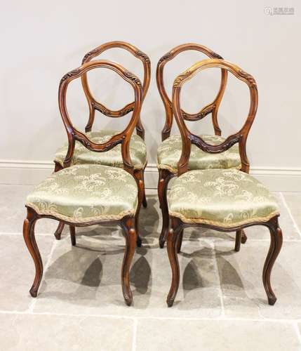 A set of six Victorian walnut dining chairs, each with a lea...