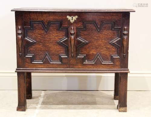 A 17th century style oak coffer bach, late 19th century, the...