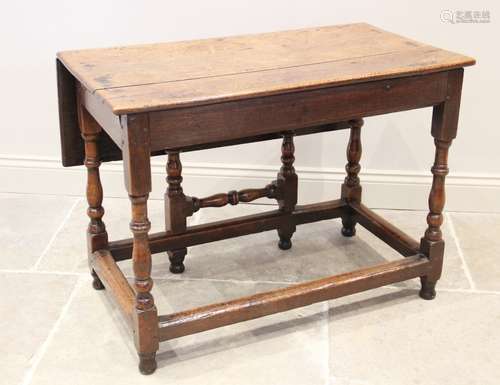 An early 18th century oak single drop leaf table, the rectan...