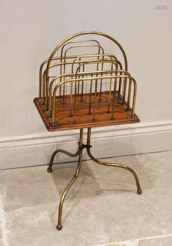 A late Victorian oak and brass revolving magazine rack, the ...