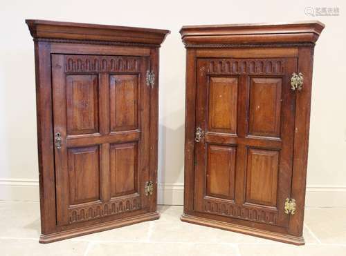 A near pair of 17th century influence oak hanging corner cup...