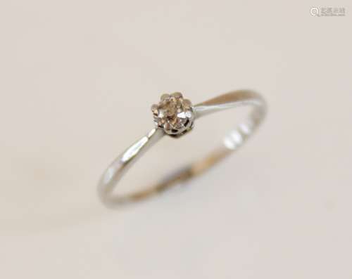 A diamond solitaire ring, comprising a central round old cut...