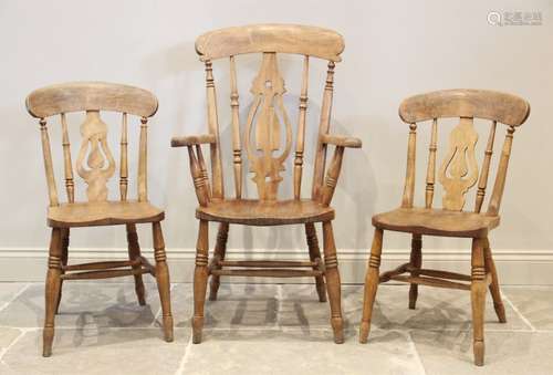 A Victorian elm and beech wood Windsor farmhouse elbow chair...