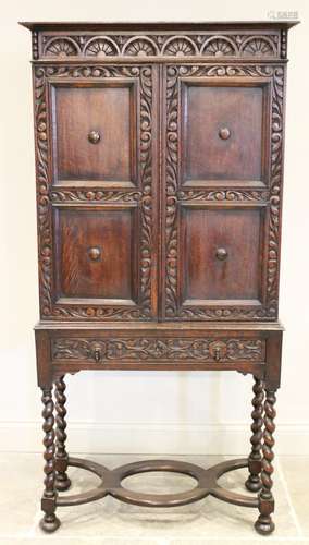 A 17th century style oak cabinet on stand, circa 1930, the l...