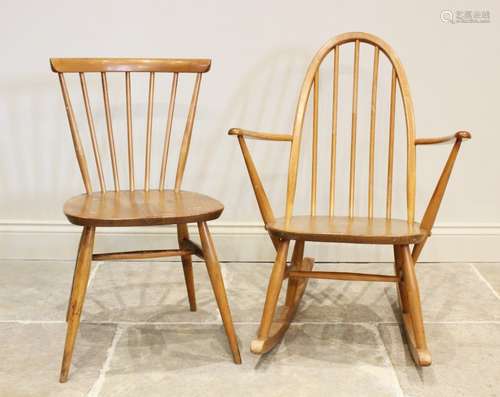 An Ercol blonde elm and beech wood stick back rocking chair,...