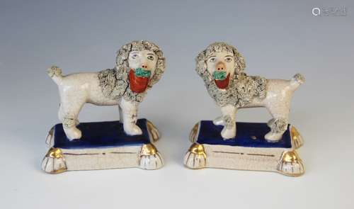 A pair of Staffordshire poodles in the manner of William Ken...