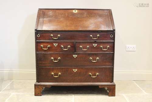 A mid 18th century oak bureau, the fall front opening to a f...