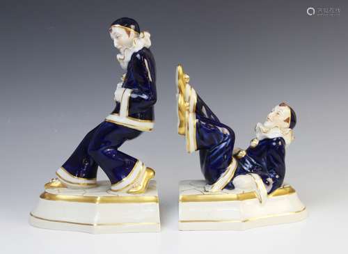 A pair of Royal Dux Pierrot bookends, one modelled leaning, ...