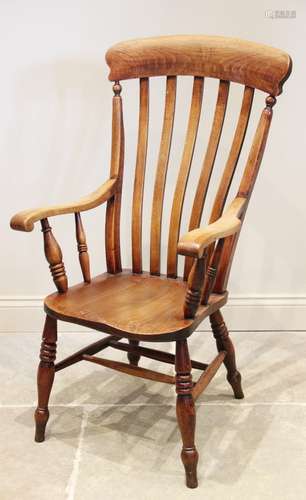 A Victorian elm and beech wood Windsor farmhouse elbow chair...