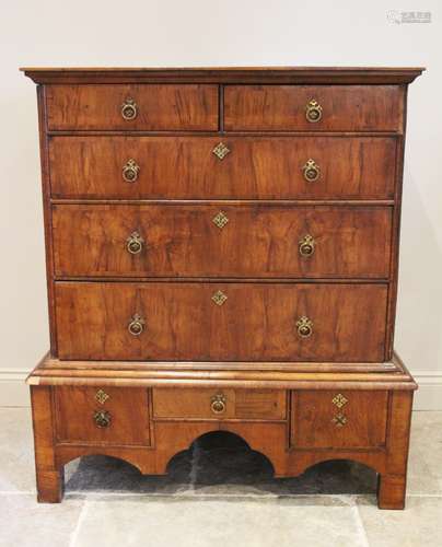 An early 18th century figured walnut chest on stand, the ove...