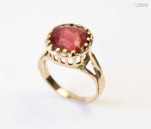 A tourmaline ring, the central orange-pink cushion cut tourm...