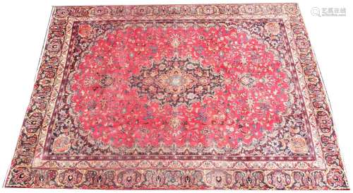 A large rich red multi coloured field Persian mashed carpet,...
