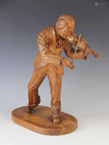 An early 20th century Hungarian figural carving of a Violini...