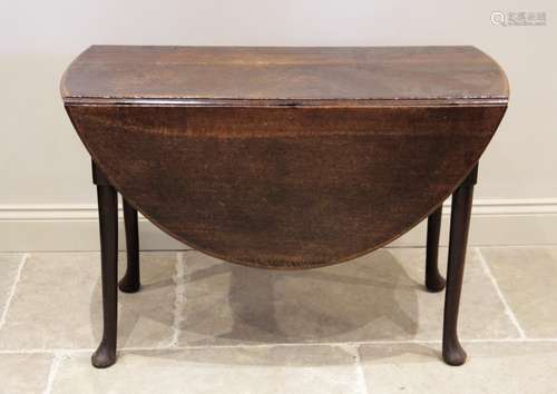 A mid 18th century oak drop leaf dining table, on tapering l...