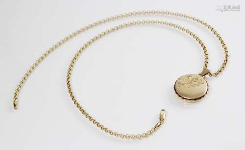 A 9ct gold locket pendant, of circular form with engraved de...