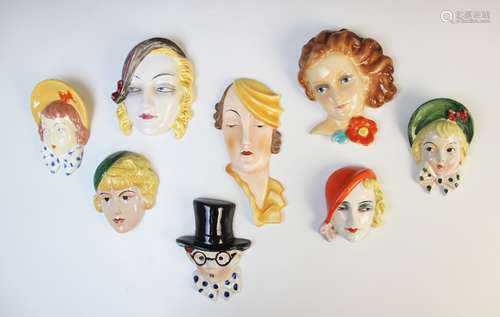 A collection of eight Art Deco miniature wall masks, by make...