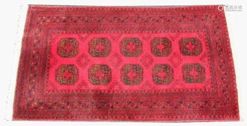 A Bokhara style rug, with ten octagonal medallions upon a vi...