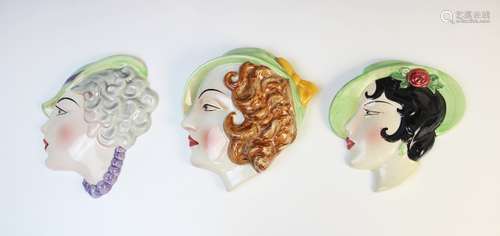 Three Art Deco wall masks by Cope & Co, each modelled as a y...