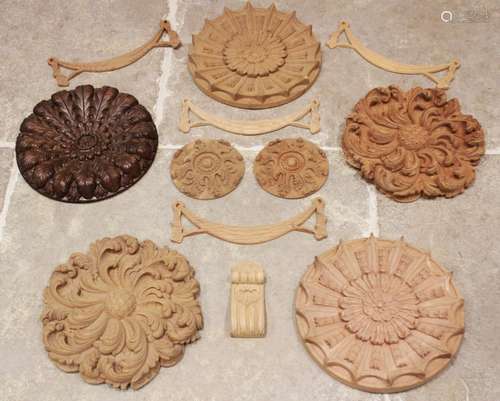 A quantity of carved architectural rose panels and wreaths o...