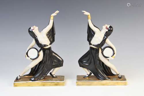 A pair of Art Deco figurines, each modelled as a scantily cl...