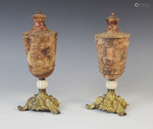A pair of Grand Tour turned stone urns, 19th century, the bo...