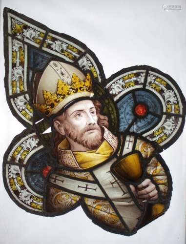 A quatrefoil stained glass portrait panel depicting an eccle...