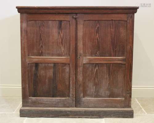 A Victorian pitch pine two door cupboard, the twin panelled ...