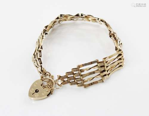 A 9ct gold gate-link bracelet, 17cm long, suspending a heart...