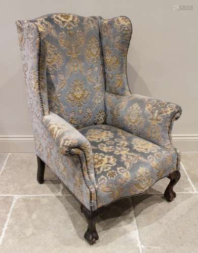 A George II style wing back fireside armchair, early 20th ce...