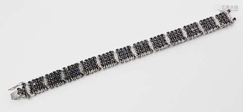 A diamond and sapphire bracelet, comprising twelve panels ea...