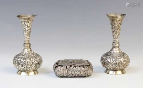 A pair of Burmese white metal posy vases, each with compress...