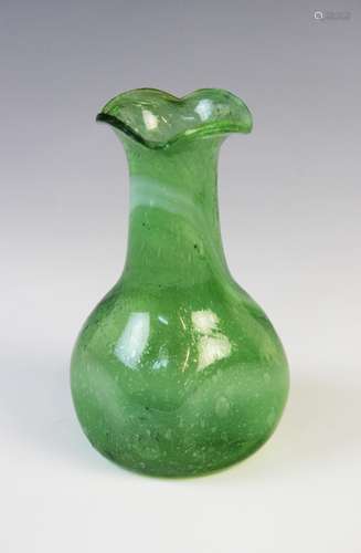 A 'Clutha' style green bubbled glass vase in the manner of C...