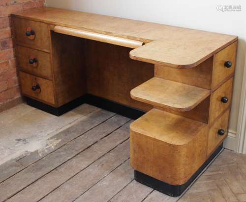 An Art Deco walnut desk, circa 1930, the rectangular top wit...