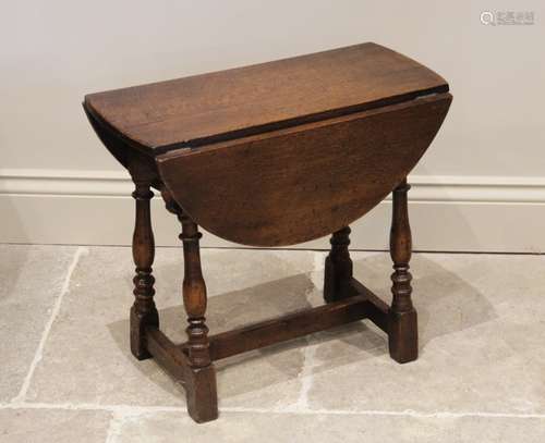 A Mouseman style oak table, early 20th century, the oval dro...