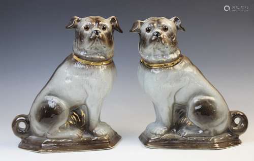 A pair of Staffordshire style Pugs, mid 20th century, natura...