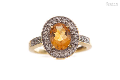 AN ORANGE GEM SET AND DIAMOND RING