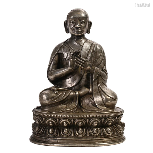 A SILVER FIGURE OF SEATED GURU, TIBET