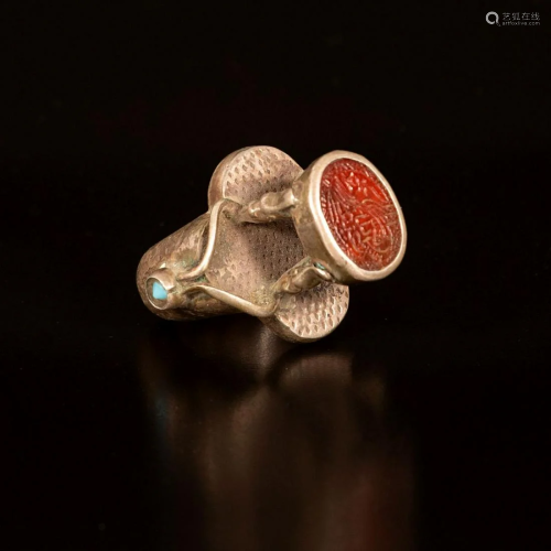 A silver ring with an engraved agate tughra seal -