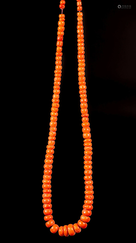 A coral necklace in gradient sizes