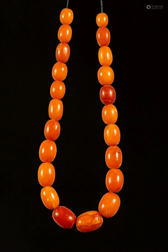 An antique persian amber necklace in gradient sizes