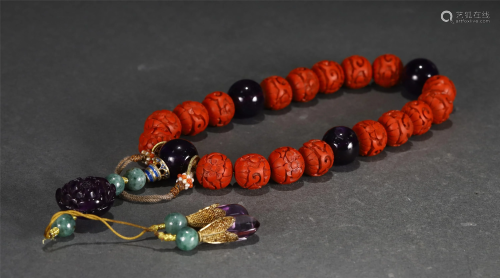 A STRING OF CHINESE CARVED RED LACQUER PRAYER BEADS