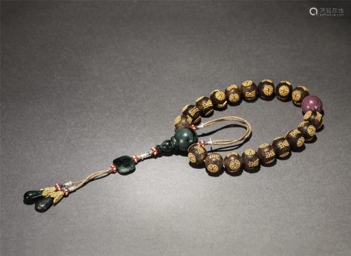 A STRING OF GILT-SILVER INLAID CHENXIANG PRAYER BEADS