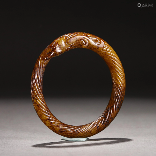 A CHINESE CARVED JADE BANGLE
