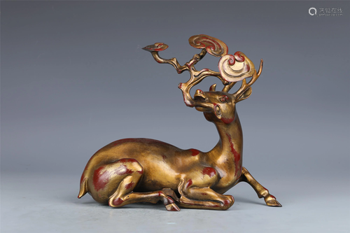 A CHINESE GOLD PAINTED BRONZE DEER HOLDING LINGZHI